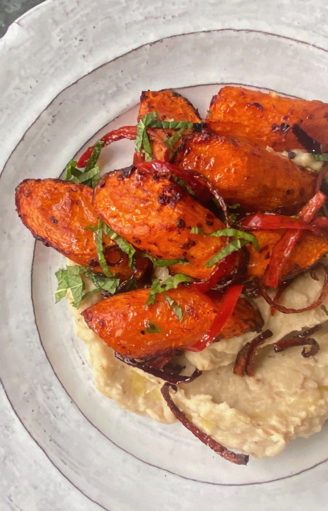 Harissa roasted carrots on garlicky butter bean mash