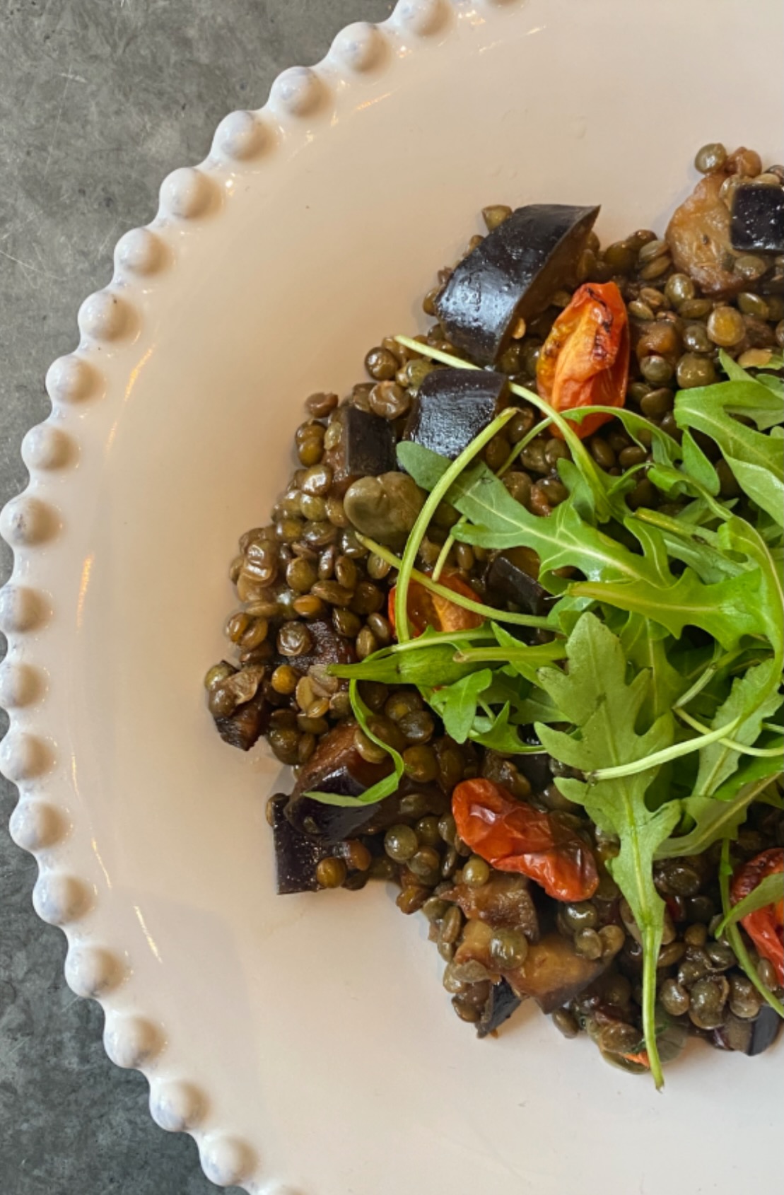Lentils with spiced, tamari aubergine, capers & rocket
